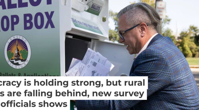 Lansing City Clerk Chris Swope collects absentee ballots from a drop box in 2024. Bill Pugliano/Getty Images
